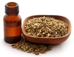 Fennel seeds with essential oil in a bottle