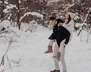 Happy Young Couple in Winter Park having fun.Family Outdoors. love