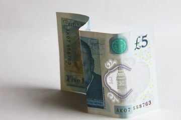 Five pound banknote on a white background.