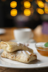 Soft focus photo of pancakes with jam and cup of coffee. Breakfast at a cafeþ