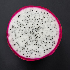 Isolated tropical pitaya, dragon fruit on black. Close up. top view.