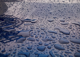 Raindrops on the hood of the car