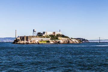 Old Prison Alcatraz island and bay bridge background in San Francisco, CA