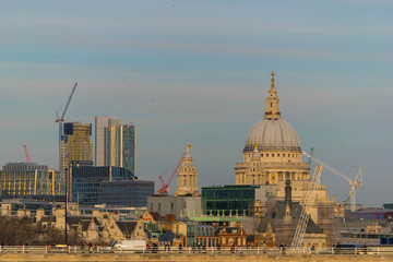 Fototapeta na wymiar London, United Kingdom, February 17, 2018: St. Pauls Cathedral, London. High angle view over the River Thames, London, with the skyline dominated by the dome of St. Paul's Cathedral