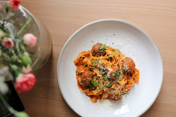 Spaghetti pasta with beef meatballs and tomato sauce on wood background . italian food on top view