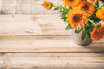Calendula on wooden table, copy space, view from above - obrazy, fototapety, plakaty