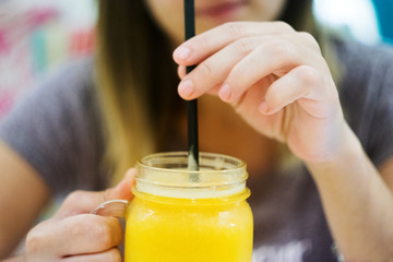 Woman drinking peach smoothy