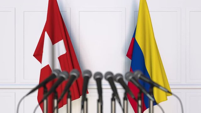 Flags of Switzerland and Colombia at international meeting or negotiations press conference