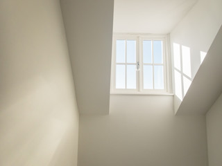 high dormer window acting as a sky light in a hall way shedding natural light into a residential home