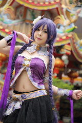 Portrait of asian young woman dancing with purple Chinese dress cosplay with temple