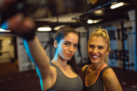 Friends having fun at the gym. Making a selfie photo.