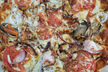 Seafood pizza , with mussel squid shrimp and tomato , italian food