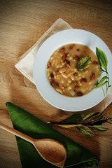 Fregola and beans soup in a white plate