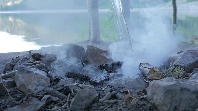 Fully putting out a camp fire to prevent forest fires