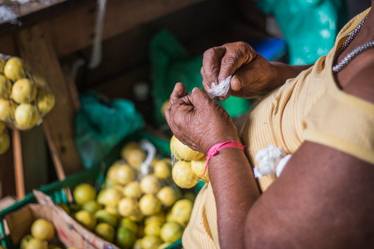 Old woman's hands tying lemon bag at the Fair