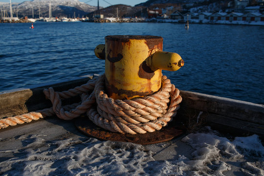 Rusty bitt at harbor in Narvik, Norway, bollar
