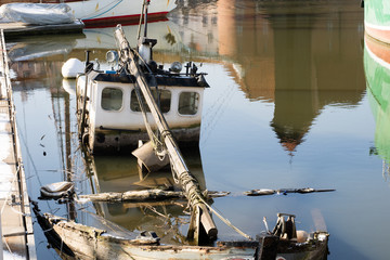 An old fishing boat. An old sunken fishing boat in the port.