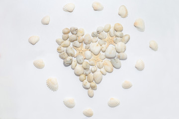 Heart on a white background lined with small white decorative stones, concept romantic, love