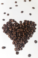 Heart from coffee beans on white background