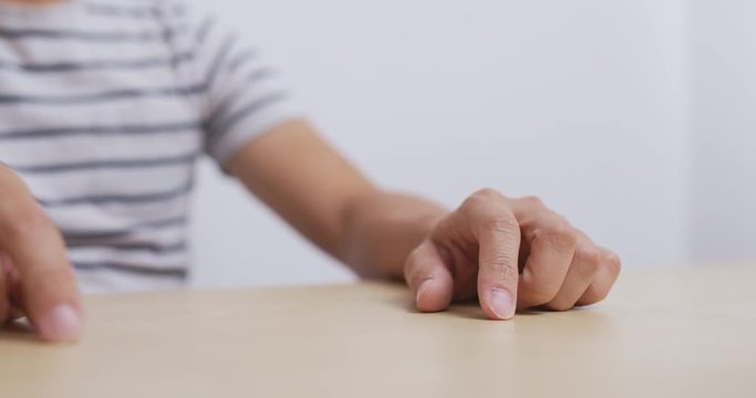 Adult man hand finger tapping on table