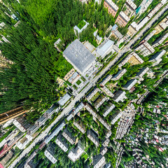 Aerial city view with crossroads and roads, houses, buildings, parks and parking lots, bridges. Helicopter drone shot. Wide Panoramic image.