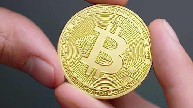 Closeup of a gold bitcoin, showing texture and detail