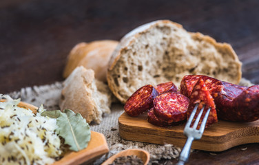 Farmer's Breakfast. Sausage, Sour Cabbage and Bread. Raw Ingredients.