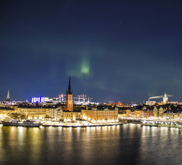 Night panorama with northern lights of Gamla Stan (Old Town), Stockholm , Sweden 