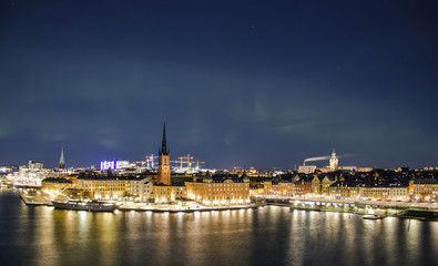 Night panorama with northern lights of Gamla Stan (Old Town), Stockholm , Sweden 
