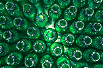Bottling plant - Green glass bottles from above. Abstract background. - obrazy, fototapety, plakaty