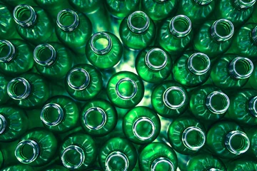Fotobehang Bottling plant - Green glass bottles from above. Abstract background. © hedgehog94
