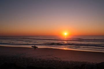 Surfer on Sunset by a beach in Aveiro