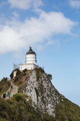 Fototapeta na wymiar Nugget Point Lighthouse, a popular tourist destination on New Zealand's Catlins Coast