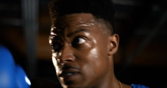 Extreme closeup of boxer's face as he throws punches