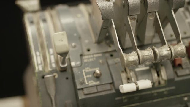 Hand pulls the brake lever on the controls in a cockpit