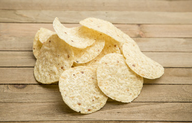 Round Tortilla Corn Chips on a Wooden Table