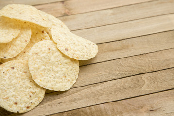 Round Tortilla Corn Chips on a Wooden Table