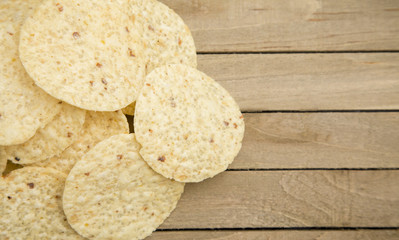 Round Tortilla Corn Chips on a Wooden Table