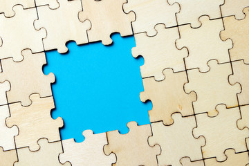 Blue background made from white puzzle pieces and place for your content