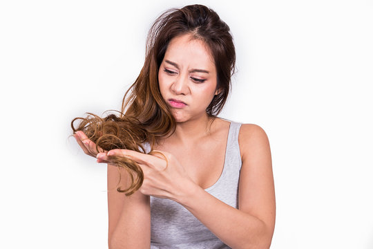 Asian women are worried about hair loss on white background.