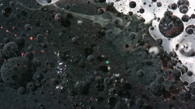 Top view Bright Collors Bubbles Slow Motion Oil Ink is fantastic structure of colorful chaotic motion bubbles stock video is a beautiful, unique, organic 4K clip.