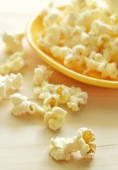 Close-up of popcorn on wooden table.