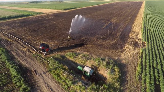 Aerial footage of land irrigation with typhon sprinkler. Preparation for sowing.