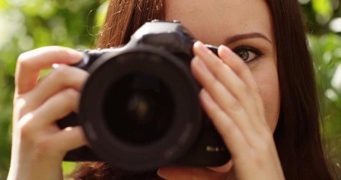 4k, young photographer takes a photo with her digital camera. Slow motion.