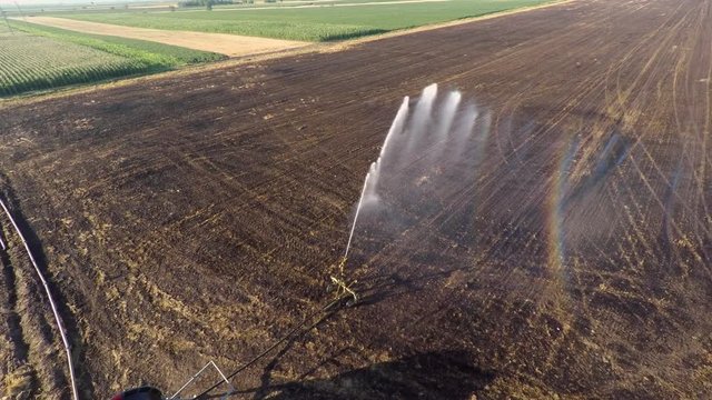 Aerial footage of land irrigation with typhon sprinkler. Preparation for sowing.
