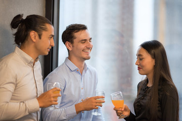 Group of business people have a drink in office after meeting.