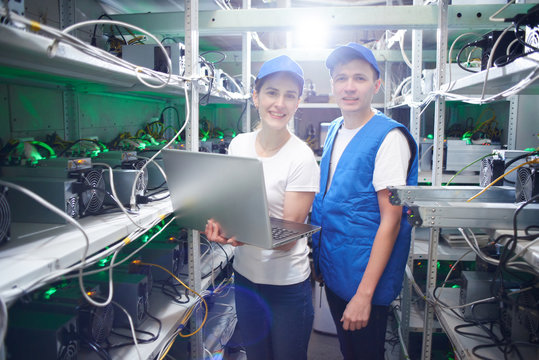 Man and woman on the farm for the extraction of crypto currencies. Bitcoin mining