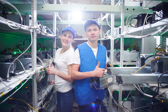 Man and woman on the farm for the extraction of crypto currencies. Bitcoin mining