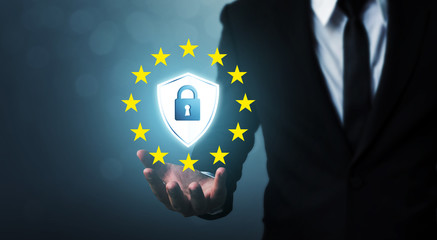 Businessman hand holding sign general data protection regulation (GDPR) and shield with key icon