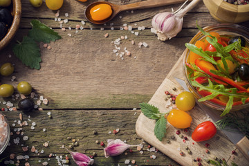 vegetables and olives on old wooden background